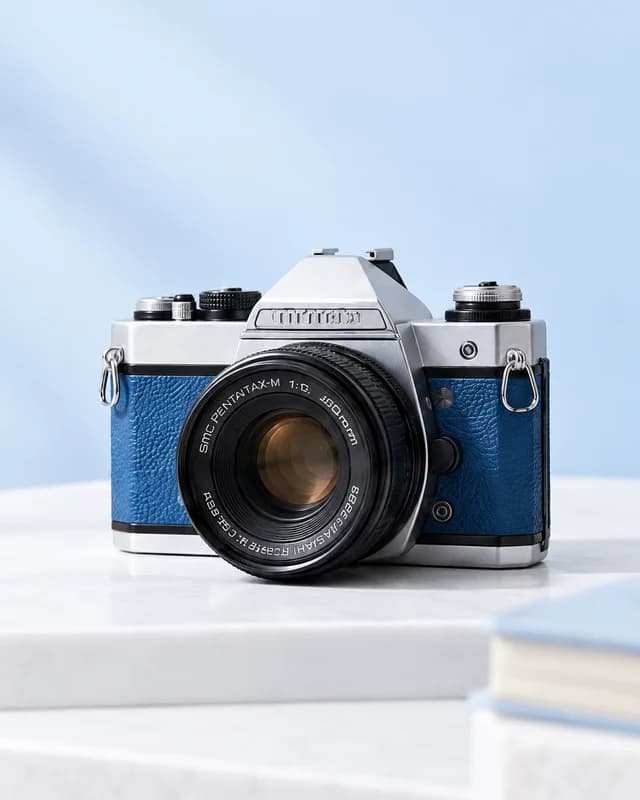 Silver vintage camera with blue leather trim