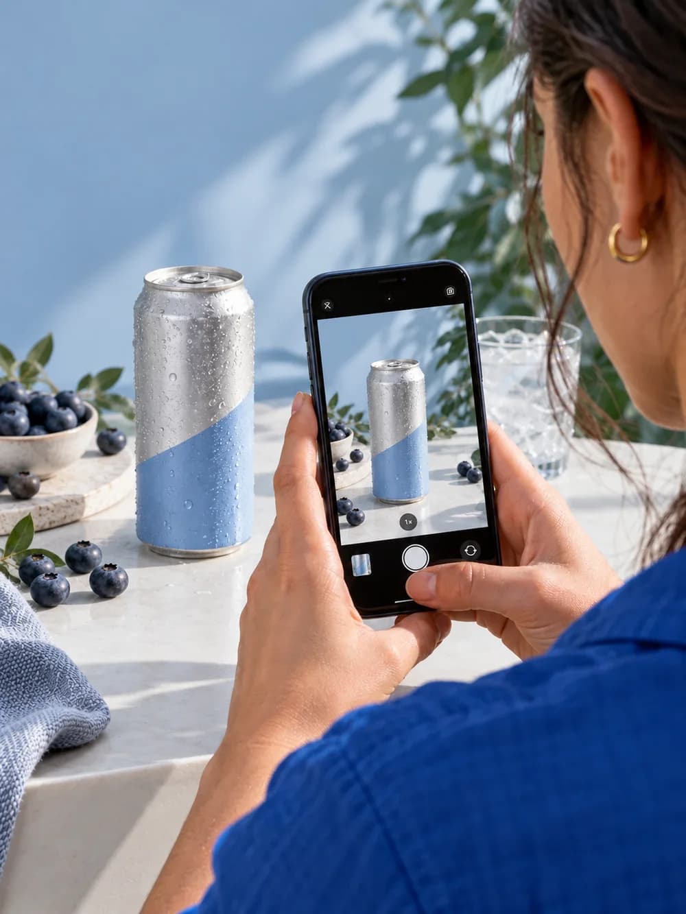 Social media creator filming a canned drink with a phone
