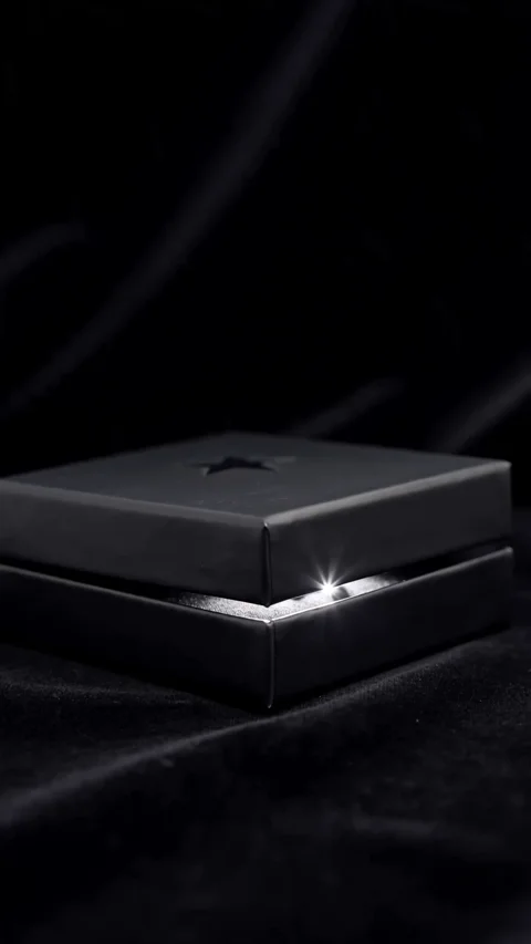 Dark presentation box opening under studio lighting